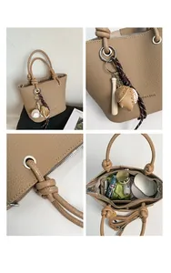 Detail of lychee pattern bucket bag featuring baseball charm and spacious inner storage