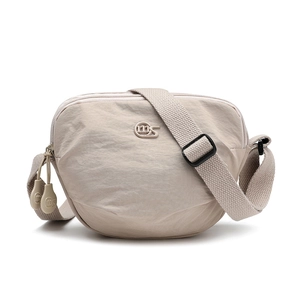 Detail of adjustable woven strap and dual zippers on beige nylon saddle bag