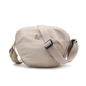 Close-up of beige nylon crossbody bag with three zipper compartments and MS logo