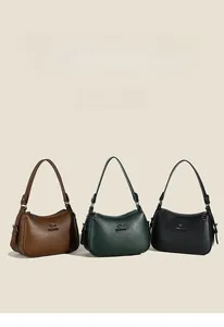 Close-up of semi-circle shoulder bags in brown, green, and black with pebble leather texture