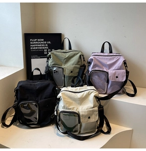 Detail of multi-functional nylon backpacks featuring a transparent PVC phone pocket window
