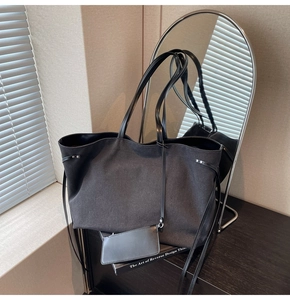 Detail of minimalist charcoal canvas tote bag showing the side drawstring and small pouch