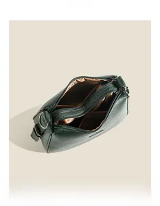 Detail view of the green lychee leather shoulder bag showing the dual zipper compartments