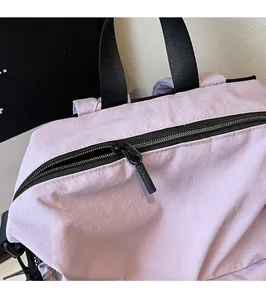 Close-up of smooth black metal zipper hardware on durable purple outdoor nylon backpack