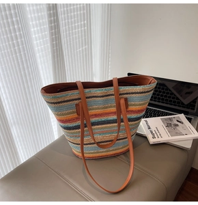 Detailed texture of multi-color striped woven tote with premium brown leather straps