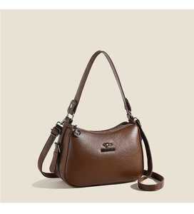 Close-up of deep brown leather tote with kangaroo logo and metallic zipper detail