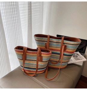 Detail of colorful striped woven tote bags with brown leather handles on a bench