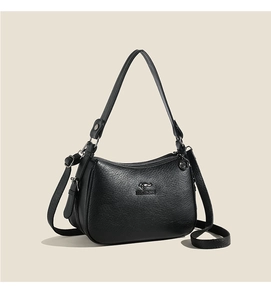 Close-up of litchi texture black leather shoulder bag with metallic kangaroo logo