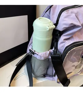Detail of purple hiking backpack showing mesh side pocket with a mint green water bottle