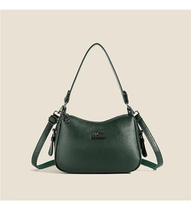 Detailed view of the dark green pebbled leather shoulder bag with a metal kangaroo logo