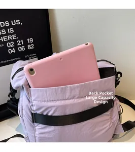 Detail of the large rear pocket on a purple travel bag fitting a tablet computer