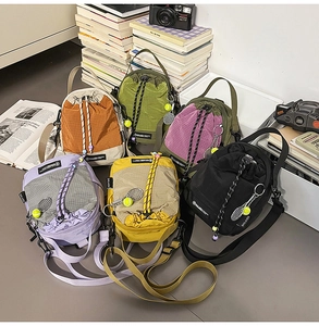 Close-up of colorful nylon drawstring mini bags with mesh pockets and tennis ball charms