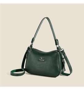 Detailed macro view of litchi grain leather texture and metal kangaroo logo on shoulder bag