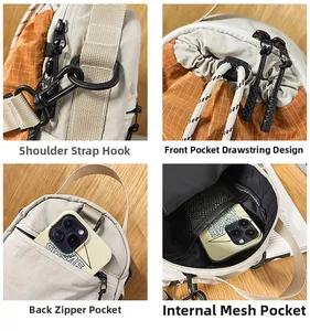 Detail view of the outdoor crossbody bag showing strap hooks, drawstring and mesh pocket