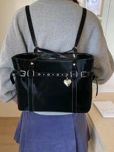 Glossy black tote bag for women with silver heart pendant and metal buckle detail