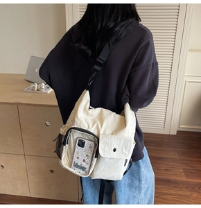 Rear view of outdoor travel crossbody bag with transparent pocket and water bottle mesh