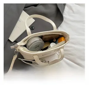 Top view of white croc-effect bucket bag interior showing spacious storage for essentials