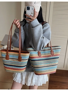 Handmade woven straw tote bag set with colorful stripes and brown leather handles for summer