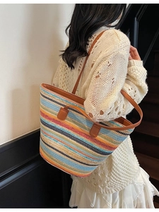 Handwoven colorful striped straw tote bag with brown leather straps for beach and travel