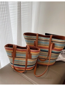 Colorful striped woven straw tote bag set with brown leather handles for beach vacation