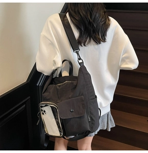 Detail of black multi-pocket travel backpack with transparent side pocket and durable strap