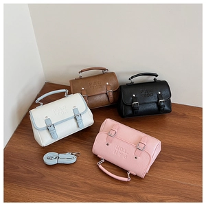Top view of four elegant square crossbody bags in white, brown, black, and pink colors