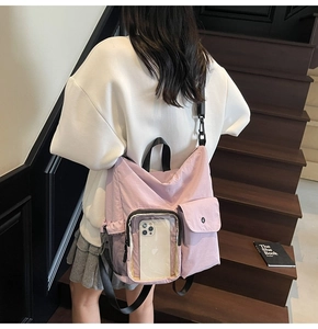 Detail of lavender canvas backpack featuring transparent phone window and mesh side pocket