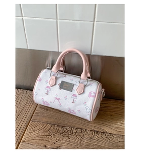 Detail of printed mini Boston bag with poodle pattern and metal brand plate