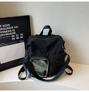 Detail of multi-functional black outdoor backpack with clear pocket and snap closure