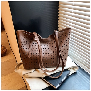 Détail du motif ajouré découpé au laser sur le grand sac cabas décontracté marron