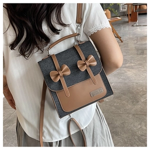 Detail of Korean retro backpack featuring denim texture and brown leather bow accents
