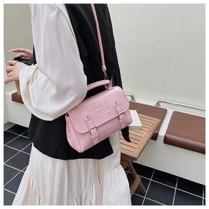 Detail of pink retro envelope handbag showing PAN TOR lettering and double buckle straps