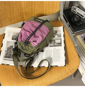 Detail of army green and purple checkered nylon crossbody bag with drawstring closure