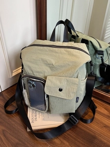 Waterproof sage green outdoor backpack with multi-pocket design and transparent slot