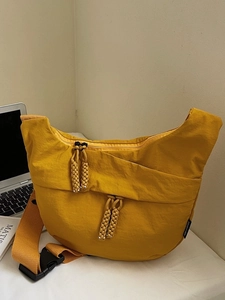 Ginger yellow nylon crescent crossbody bag with braided zipper and plastic buckle