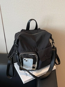 Large black outdoor travel backpack with multiple pockets and a transparent phone slot