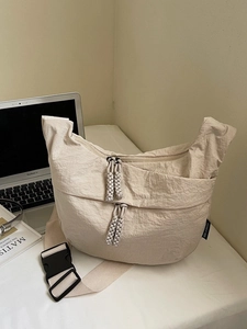 Minimalist beige nylon dumpling crossbody bag with large capacity for work or travel