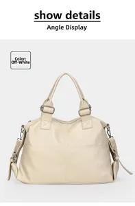 Detail view of creamy white textured leather tote with cross stitching and silver hardware