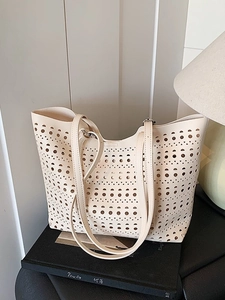 Sac fourre-tout minimaliste crème en cuir découpé au laser avec fines bandoulières sur livres