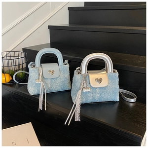 Detail of light blue quilted mini bags with heart buckles and silver leather accents