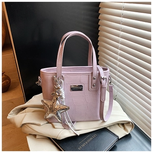 Detailed close-up of purple crocodile pattern PU leather bucket bag with silver star charm