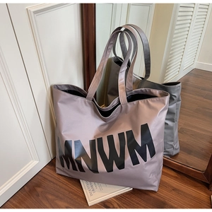 Detail of mauve tote bag with black MNWM letter print on high density fabric material