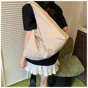 Detail view of striped tote bag with Paris embroidery and large capacity on model