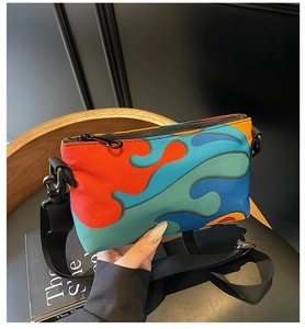Detailed top view of a colorful rectangular crossbody bag with vibrant abstract print