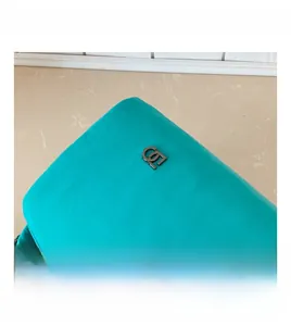 Macro shot of tiffany blue fabric bag showing neat stitching and gunmetal logo detail