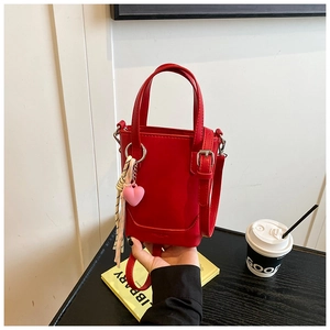Mini sac seau rouge avec pendentif cœur et foulard décoratif en vue rapprochée