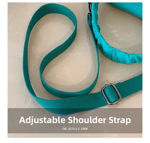Detail of adjustable nylon shoulder strap with dark grey metal buckle for crossbody bag