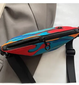 Top detail of flame pattern crossbody bag showing smooth metal zipper and nylon strap