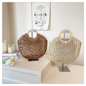 Detail of hollow woven tote bag with wooden ring handles and soft fabric lining