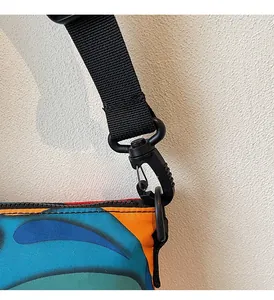Detail of the durable black swivel hook and strap on this colorful crossbody bag